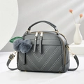 Deep grey litchi leather crossbody bag with V-shaped stitching and plush pompom charm - Dark Gray
