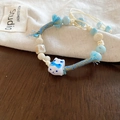 Detail of hand-woven beaded bracelet with a cute ceramic cat charm and blue accents - Blue Cat