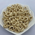 Macro view of cream heart-shaped ceramic beads for DIY jewelry making in a lace bowl - Light Coffee/Beige