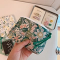 Close-up of green floral cotton coin purse with white zipper and Simple Wish label - Green Garden