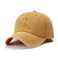 Close-up of washed cotton baseball cap in mustard yellow showing fabric texture and vent holes - Adjustable / Turmeric
