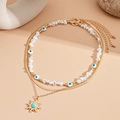 Collar multicapa dorado con perlas, ojo de diablo y colgante de sol con piedra turquesa - Dorado (Juego de 3 piezas)