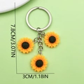 Sunflower keychain with three yellow pendants and size labels on green background - Triple Sunflower