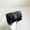 Chic black quilted crossbody bag with gold chain strap and SS logo with tassel charm - Black