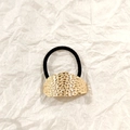 Golden hollow metal ponytail holder with hammered texture on black elastic band - Gold Pitted Texture 5cm