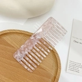 Elegant wide-tooth acetate hair comb featuring a pink marble floral pattern texture - Pink