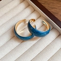 Chic C-shaped gold hoop earrings with blue marble enamel finish on a beige jewelry tray - Standard / Gold and Blue