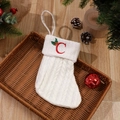 White cable knit Christmas stocking with red embroidered letter C and holly berry leaf - Letter C