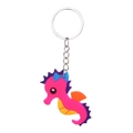 Close-up of pink seahorse cartoon keychain made of soft PVC with silver metal ring - Seahorse