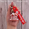 Gingerbread house PVC keychain with red Christmas strap and golden metal ring - Christmas Snow House
