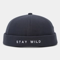 Close-up of navy blue cotton docker hat featuring white Stay Wild embroidery detail - Adjustable / Dark Gray