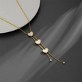 Detail of 18k gold plated Y-necklace with three white heart pendants and crystal beads - Three Embossed Heart Necklace (C611)