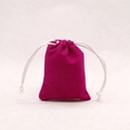 Macro detail of small rose red velvet drawstring jewelry pouch with white cord closure - Plum Red