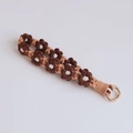 Handmade woven flower keychain with brown and beige daisies and golden spring ring - Coffee