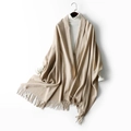 Thick camel wool scarf with fringe hem, styled over a white turtleneck sweater - Beige