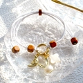 Detail of woven bracelet with gold moon, pearl rabbit and white flower charms - White Woven Rope Pearl Rabbit Moon Charm Bracelet