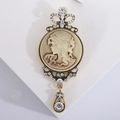 Vintage relief brooch with woman portrait cameo and sparkling rhinestones on stand - Gold