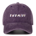 Close-up of white ENEMIES embroidery on a washed dark purple denim cotton baseball cap - Purple