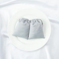 Elegant light gray satin drawstring jewelry bags on a white ceramic plate - Gray