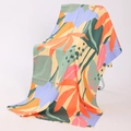 Double-sided microfiber beach towel with vibrant tropical leaf patterns on a folding chair - U-Colorful Tropical Plant Leaves Multicolor