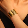 Adjustable wide stainless steel leaf pattern cuff bracelet in a polished golden finish - Snake Scale