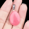 Pink teardrop crystal pendant with silver bail shown in a detailed handheld view - Pink Jade (Dyed) (1pc)