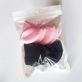 Detailed view of pink triangular powder puffs and black headband in a transparent bag - 8pcs in Bag / Black & Pink Mixed