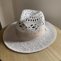 White hollow-woven straw sun hat with light beige ribbon on a wooden table - Hollow White Panama Hat - Beige Ribbon