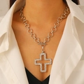 Detailed close-up of a silver cross pendant necklace with clear crystals on a model - Silver Necklace (Hollow Cross S264)