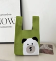 Green knit bucket tote bag featuring a cute white and black bear pattern design - Green Black Ear Dog