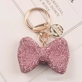 Detalle de llavero con lazo de diamantes de imitación rosa y herrajes dorados - Rosa
