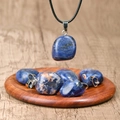 Deep blue irregular natural stone necklace pendant with a black leather cord strap - Lapis Lazuli