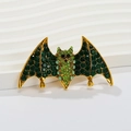 Golden bat brooch with green rhinestones and vintage gothic style design - Yellow