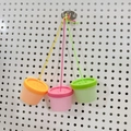 Three colorful plastic canisters with hanging cords for DIY busy board sensory toys - Triple Twist Cap Toy