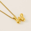 Golden bubble letter M pendant necklace with a polished metallic finish on white background - Letter W