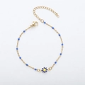 Golden chain bracelet featuring delicate blue beads and a blue daisy floral pendant - Gold + Royal Blue