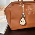 Handmade brown wool felt loquat fruit pendant attached to a luxury leather handbag - Pipa Lute Pendant