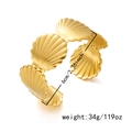 Macro shot of gold shell bangle detailing its 6cm inner diameter and 34g weight specifications - Shell