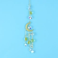 Detail view of golden crescent moon suncatcher with hanging crystals and star charms - Gold