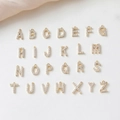 Flat lay of 26 large 14K gold plated letter pendants with cubic zirconia for DIY jewelry - Letter A / 14K Gold