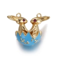 Golden bunny in blue enamel Easter egg pendant with red gemstone eyes and floral patterns - Blue Easter Egg Rabbit Pendant