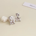 Close-up of geometric earrings with heart and rectangular clear crystals in silver prongs - Rhodium Plated Silver Heart Zirconia Earrings