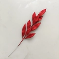 Macro shot of red glitter artificial leaves for Christmas home holiday decorations - Red
