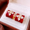 Detailed macro view of 18K gold plated flower C-shaped earrings with red enamel - Gold/Red (18K Gold Plated Silver Pin)