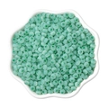 4mm pale green cat-eye glass beads in a white ceramic bowl for DIY jewelry making - Verdant
