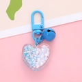 Detail of blue heart-shaped keychain with colorful beads and small bell charm - Blue