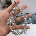 Silver rhinestone bear phone strap with pink heart crystal shown being held - Colorful Rhinestone Bear Pink Heart