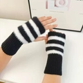 Detail of warm black and white striped fingerless gloves with soft faux fur texture - Striped Black