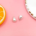 Macro detail of teardrop-shaped white pearl pendants with silver metal loops on pink background - 8X10mm / White K/Silver