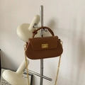 Brown semi-circular shoulder bag with twist handle and golden chain strap for women - Brown